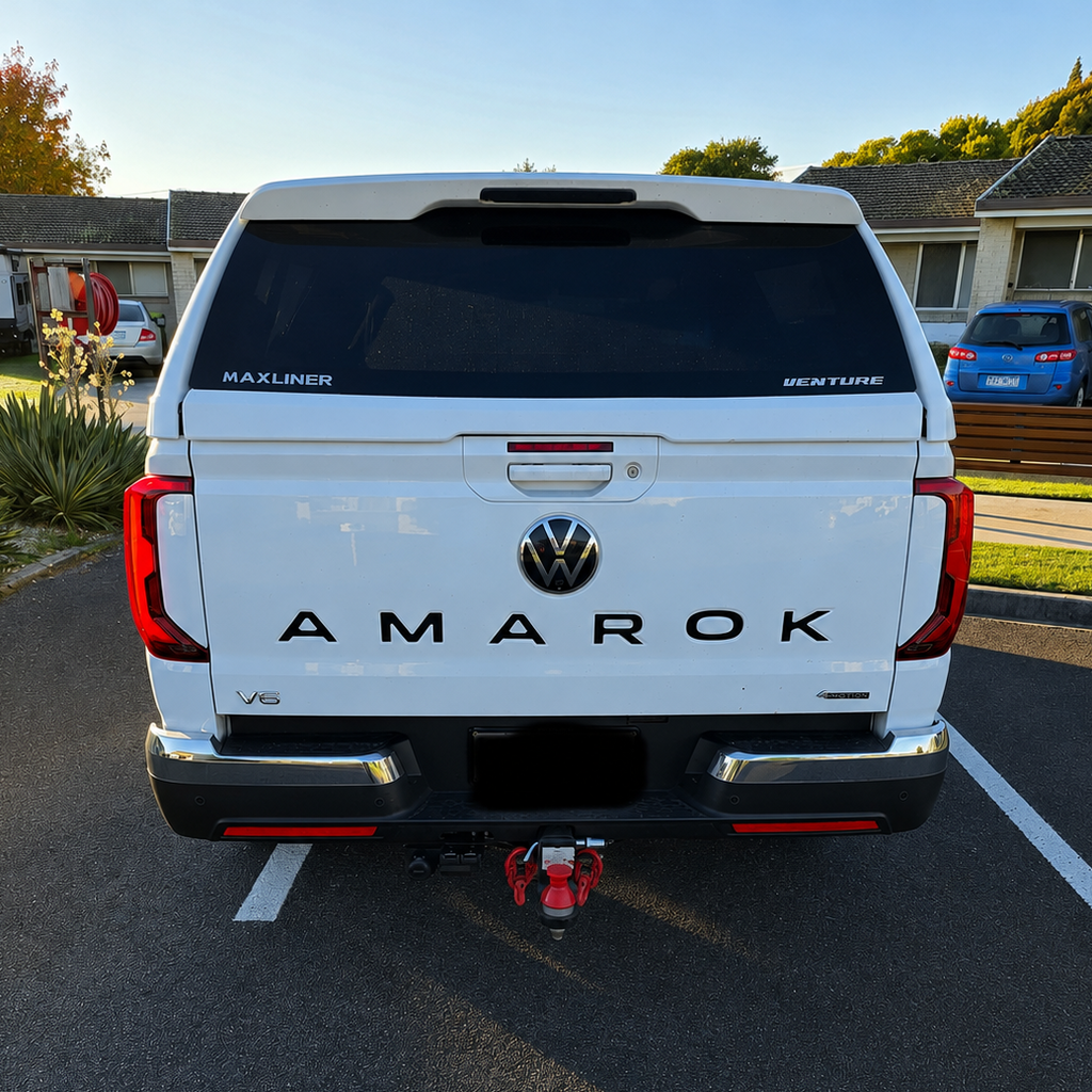 Black AMAROK tailgate infill lettering fitted to a white Volkswagen Amarok